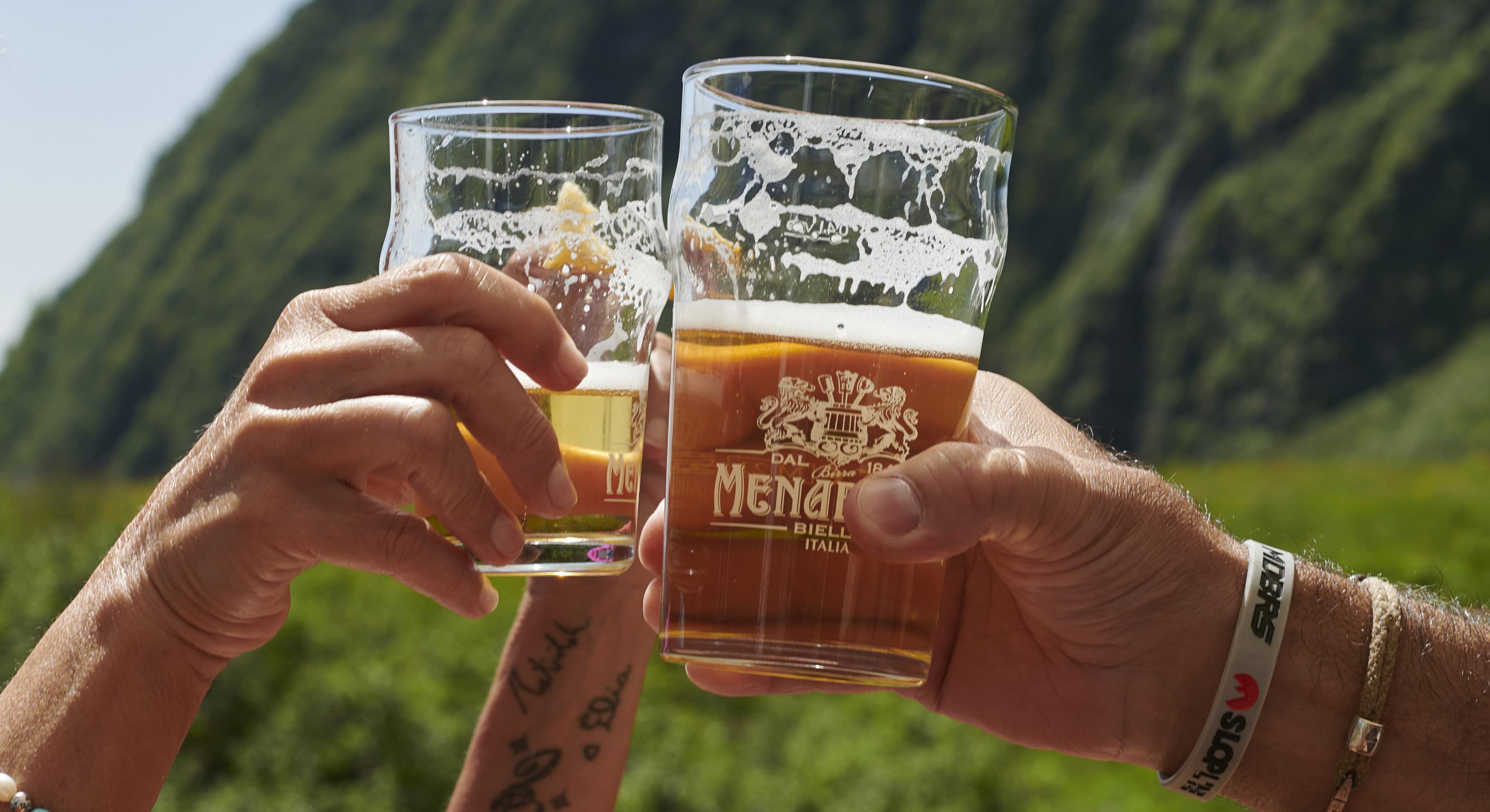 Brindisi con birre davanti alle montagne